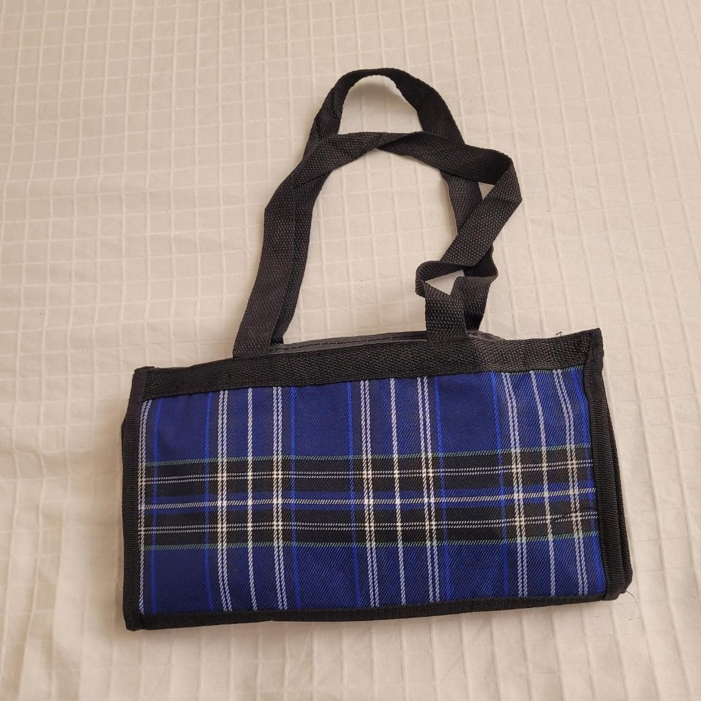 Blue plaid collapsible wheeled travel bag with small makeup bag.